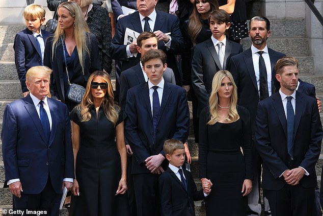 Donald Trump and his wife Melania watch with their son Barron and Ivanka, Eric and Don Jr. and their children watch as Ivana Trump's coffin is placed in a hearse outside St. Vincent Ferrer Roman Catholic Church on July 20, 2022. New York City