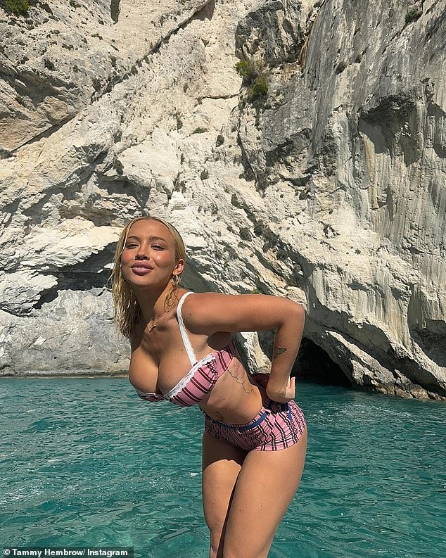 Tammy Hembrow has enjoyed the results of her latest breast implant surgery and put her busty on display as she posed in a skimpy pink bikini