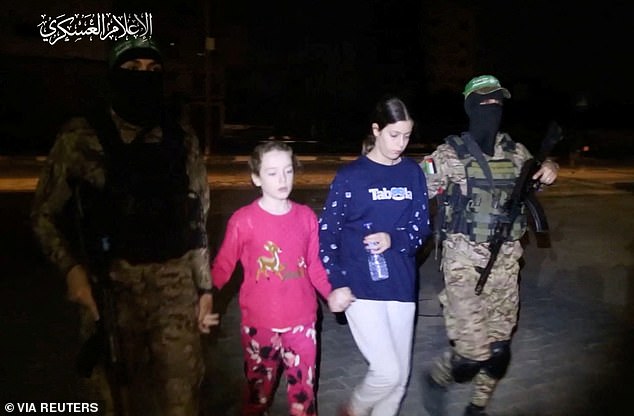 Emily is brought to safety by armed Hamas militants after 50 days in captivity