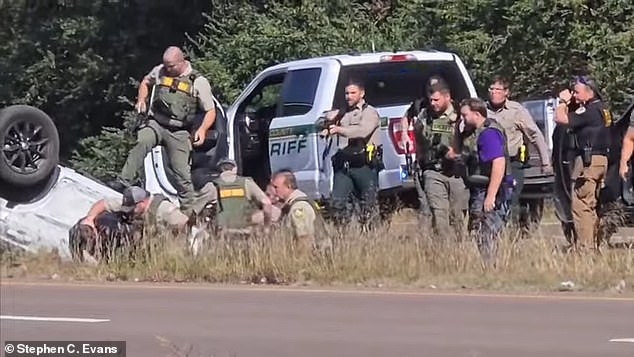 Hopper (pictured in pajama bottoms) was dragged from his car and then brutally beaten for about 30 seconds, as seen in a bystander's cell phone footage