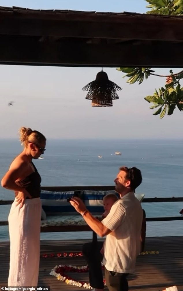 Greene gets down on his knee and proposes to his partner Georgia while on vacation