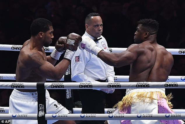 Ngannou returned to MMA after boxing fights against Anthony Joshua (pictured, left) and Tyson Fury this past year