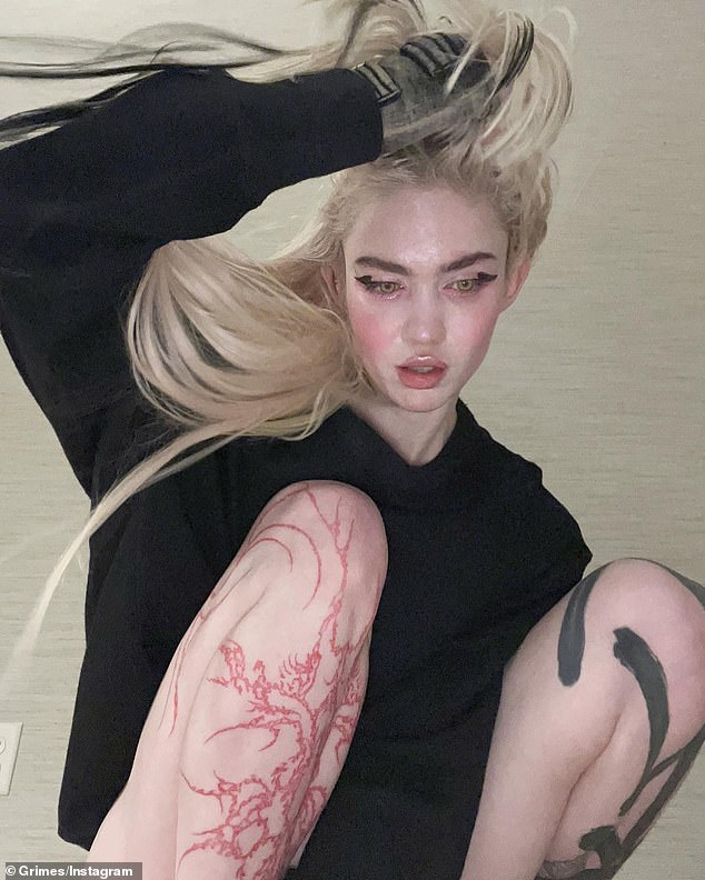 Grimes depicted with a cybersigilism tattoo on her leg. Gen Z's latest tattoo trend is