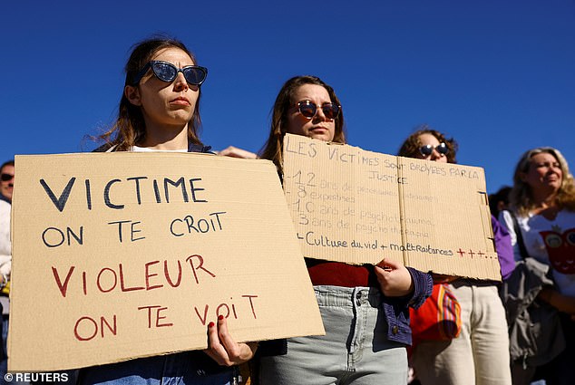 A woman holds a sign that reads: 'Victim, we believe you rapist, we see you', during a silent march in support of Gisele Pelicot