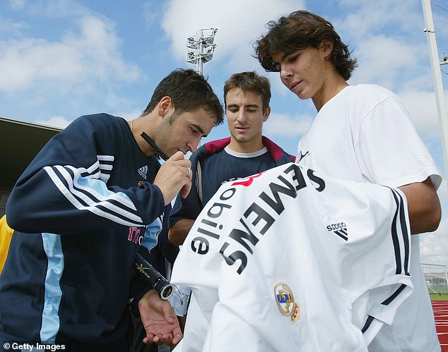 A young Rafa Nadal has his Real Madrid shirt signed by Spanish football legend Raul