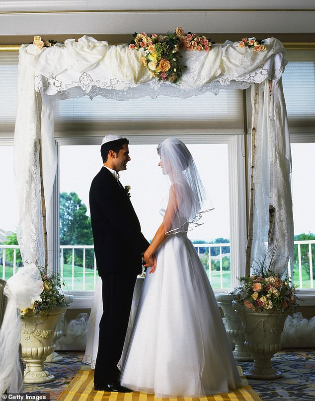 On what should have been one of the happiest days of her life, 55-year-old Janet Davis suffered injuries to her spine and inner ear after a chuppah fell on her during her son's wedding in 2021. Pictured: A couple stands under a chuppah