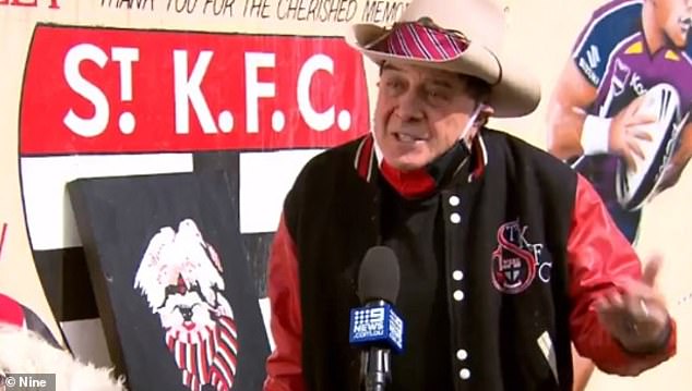 The veteran entertainer appears unrecognizable at the beginning of the clip until he suddenly puts on his signature hat, revealing it to be none other than Molly Meldrum