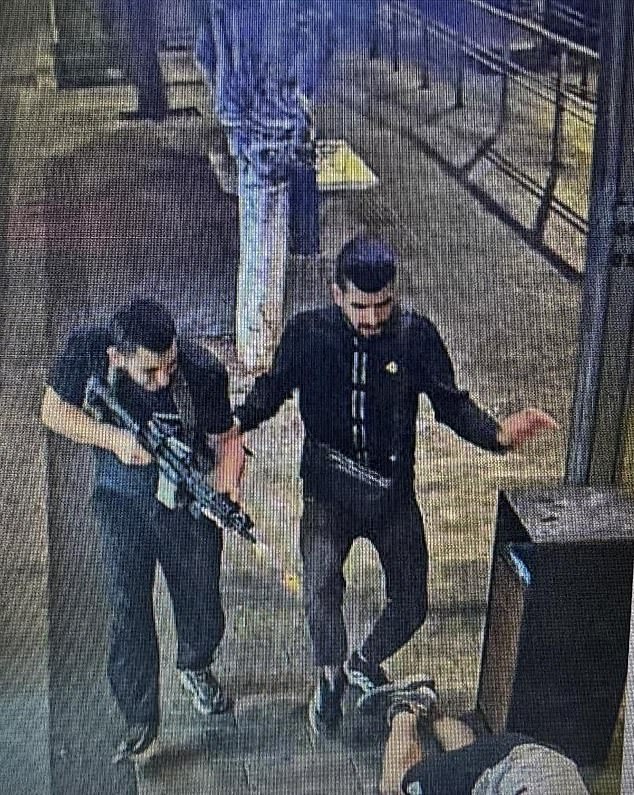 Pictured: Gunmen on the streets of Jaffa, Tel Aviv, Tuesday evening