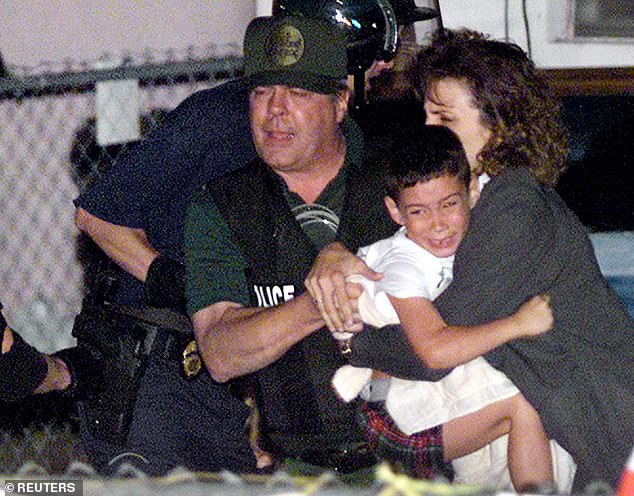 Pictured: A U.S. agent transports Elian Gonzalez as federal agents stormed the Cuban shipwreck survivor's home in Miami on April 22, 2000, tearing him away from his relatives in Miami who moved in the early morning hours to end a bitter international battle over the to end detention