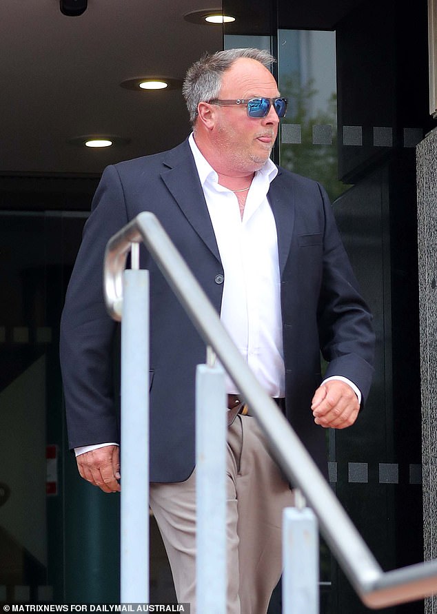 Ashley David Hallam remains tight-lipped as he leaves the Hobart Magistrates Court on Friday after pleading not guilty to bestiality offenses relating to an alleged live fishing sex video