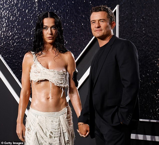 Katy Perry tried to use her romance with fiancé Orlando Bloom as a means to boost interest in her new album, 143, insiders told DailyMail.com