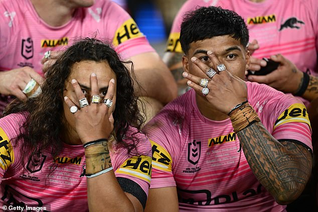 Jarome Luai (left) and Brian To'o pose with all four of their premiership rings after their 14-6 win over Melbourne on Sunday night