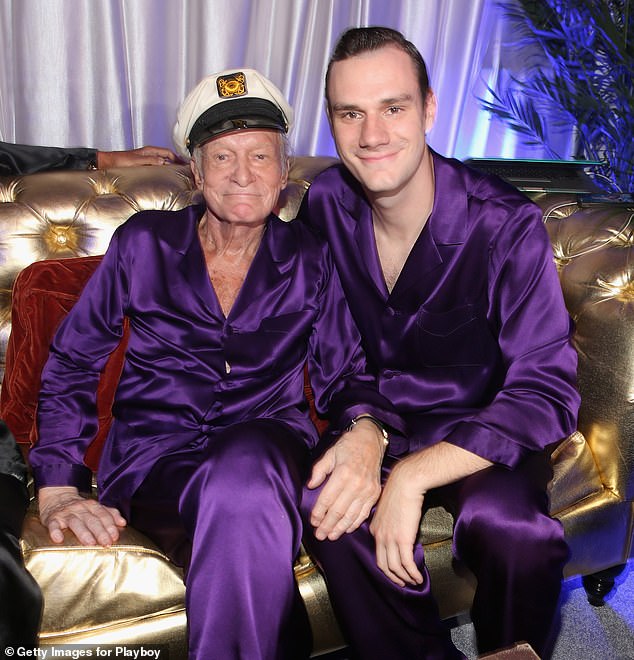 Hugh Hefner's son Cooper has made a $100 million offer to acquire Playboy Enterprises; Cooper and his father pictured in 2014