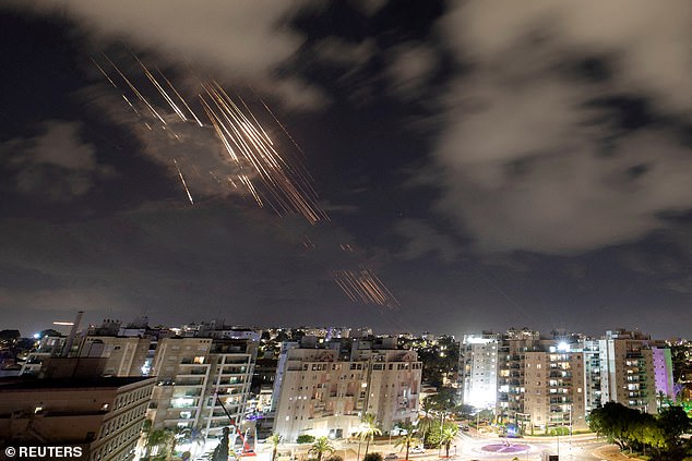 Israel was confronted last night with a devastating salvo of approximately 180 ballistic missiles fired from Iran (pictured shows some of the missiles firing towards Israel)