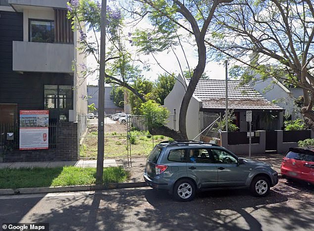 Temperatures are rising in the Sydney suburb of Alexandria due to plans to build a six-storey building on a narrow plot of land the same width as a car park (pictured)