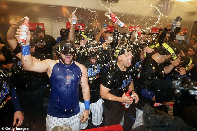 The Mets celebrate in the locker room after beating the Phillies 4-1 in Game 4 of the NLDS