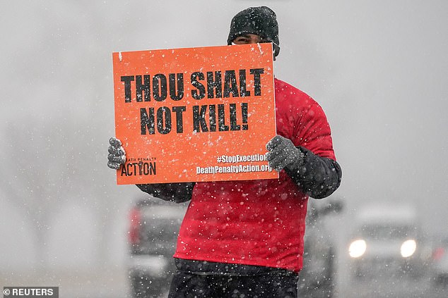 An activist opposing the death penalty protests during a snowstorm outside the United States Penitentiary in Terre Haute, Indiana, U.S., January 15, 2021