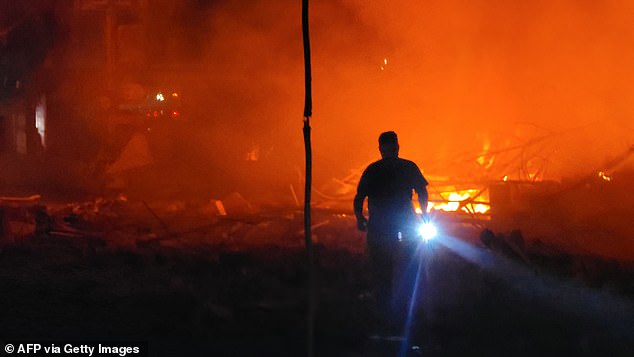 A rescue worker searches for survivors at the site of an Israeli airstrike on the southern Lebanese city of Nabatiyeh