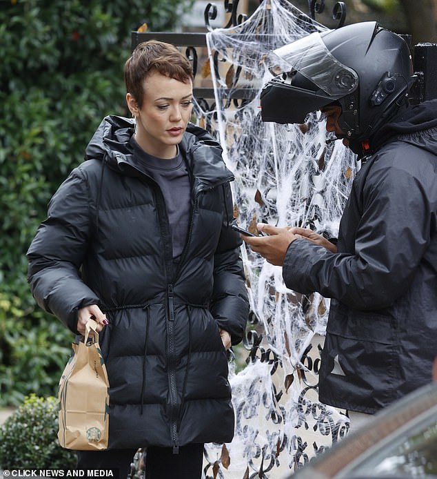 She seemed in good spirits and was spotted picking up a Starbucks takeaway from a delivery person