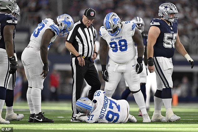 Aidan Hutchinson (97) of Detroit Lions is controlled by, among others, DJ Reader (98).