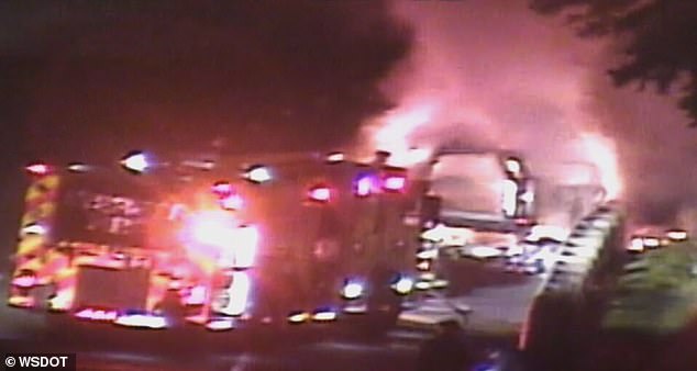 Huge clouds of red and black smoke began to saturate the frame as firefighters hosed down the vehicle, seemingly bringing the incident under control within minutes.