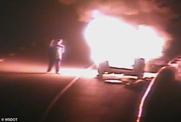 Traffic cameras in Washington captured the moment an unnamed man staggered into the rightmost lane of a highway before apparently taking a selfie with the raging fire