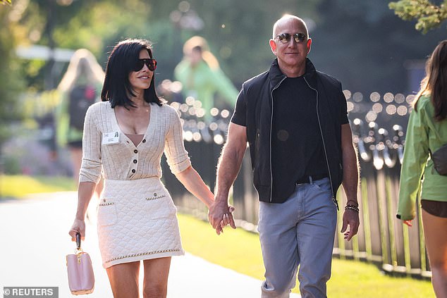 Above, Jeff Bezos and Lauren Sanchez take a stroll through the Sun Valley Resort in Idaho, July 10, 2024. Bezos' fiancée Sanchez confirmed her partner's commitment to keeping his morning hour 