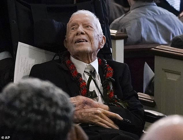 Jimmy Carter turns 100 today and has expressed his birthday wish: he can vote for Kamala Harris. He is pictured at the funeral of his beloved wife Rosalynn last year