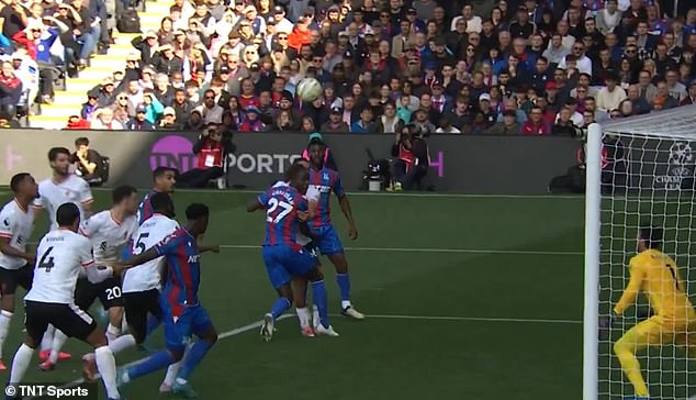 Liverpool No. 4 Virgil van Dijk pictured holding the arm of Crystal Palace defender Marc Guehi