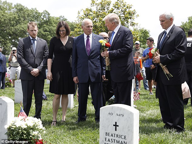 President Donald Trump speaks with Secretary of Homeland Security John Kelly and Vice President Mike Pence before laying flowers at the grave of Kelly's son, First Lieutenant Robert Kelly, at Arlington National Cemetery on May 29, 2017. Lt. Kelly was killed in 2010 while leading a patrol in Afghanistan