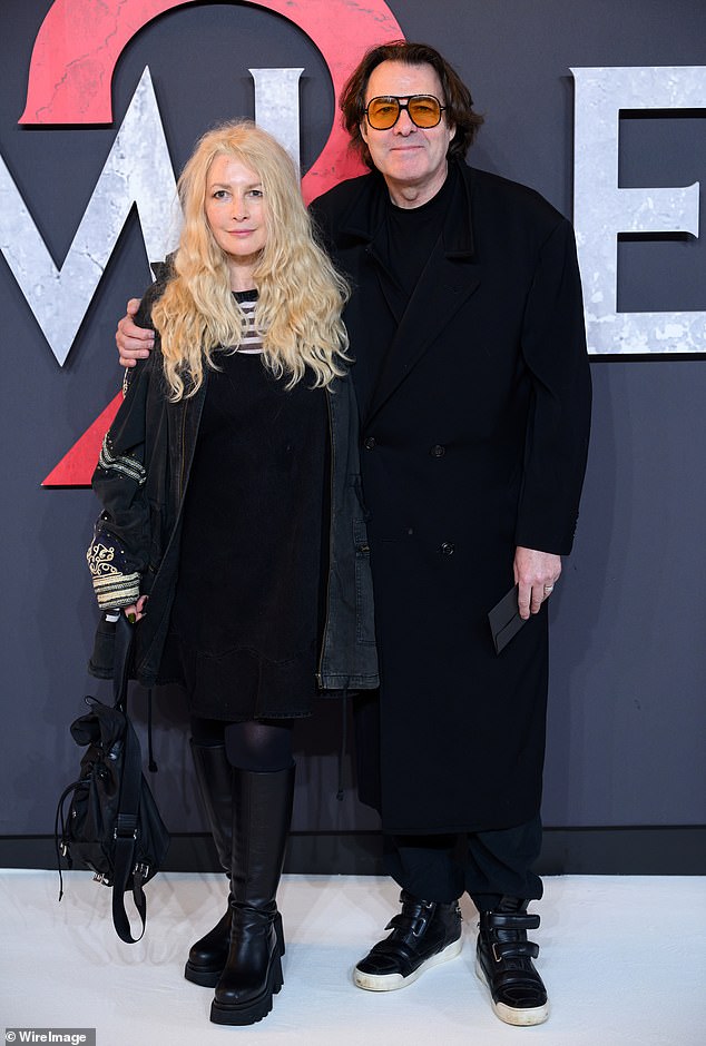 Jonathan Ross got cozy with his wife Jane Goldman as the couple posed at the Smile 2 UK screening at the Odeon Luxe Leicester Square on Tuesday evening