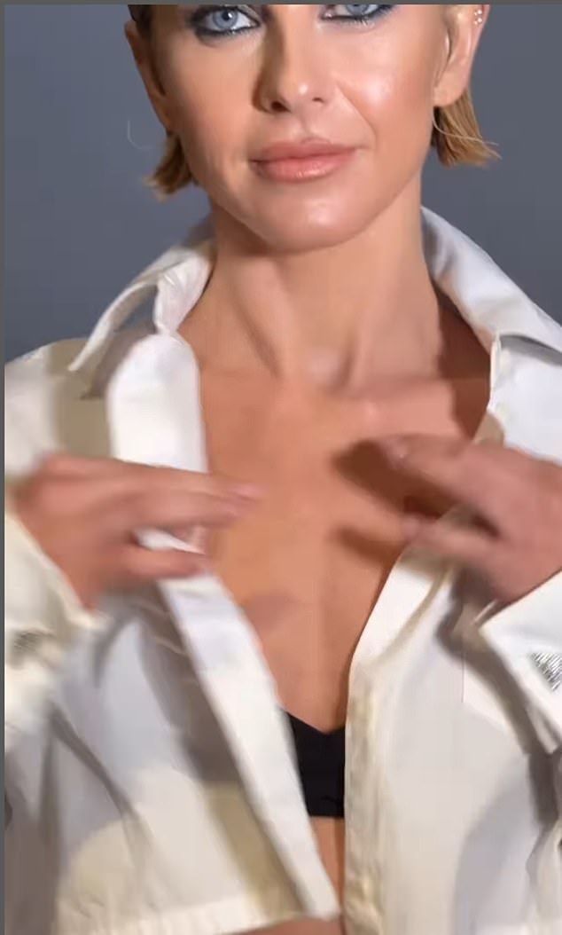 Here you can see her taking off her white shirt at the beginning of the clip