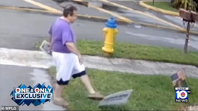 Pictured: The man walks onto the veteran's property and kicks the sign but fails to knock it down