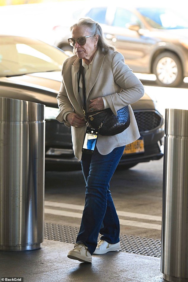 The Academy Award-winning actress walked through the sliding doors of the airport wearing skin-tight jeans with a tan blazer, tan shirt and white sneakers.