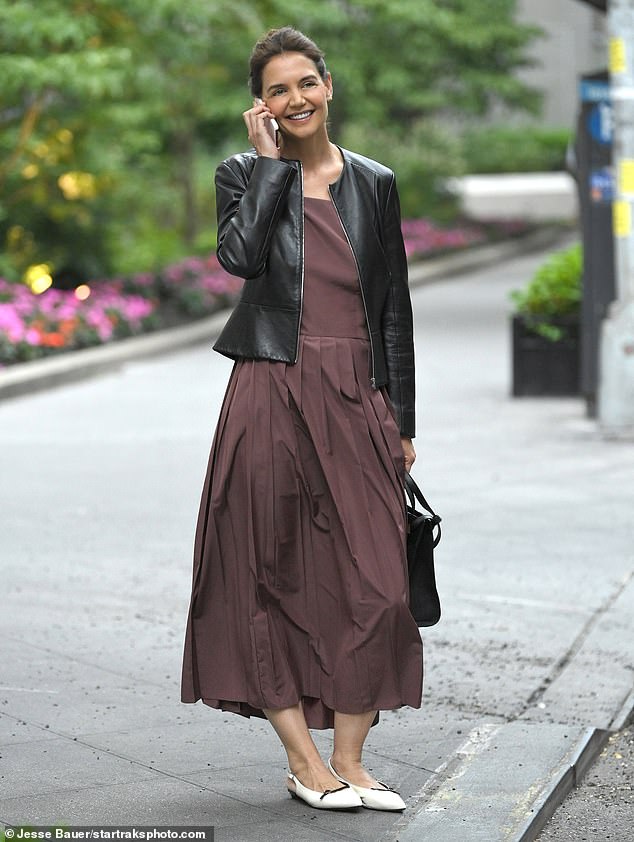 Katie Holmes was smiling from ear to ear as she was spotted out and about in New York City on Wednesday. The Dawson's Creek veteran was glued to her cell phone during what appeared to be a cheerful conversation