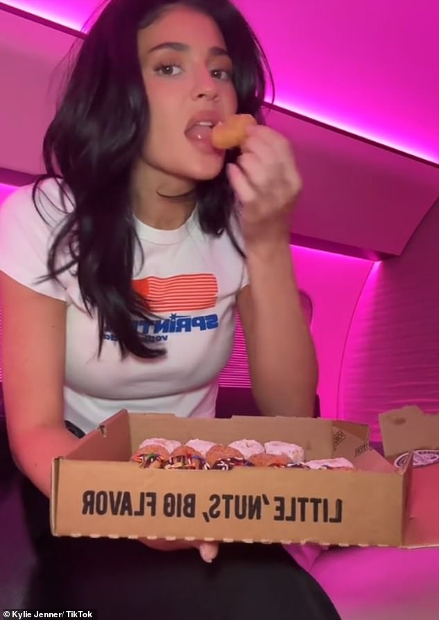 Kylie lay in bed on her private jet eating donuts while catching up on the BBC show on her iPad