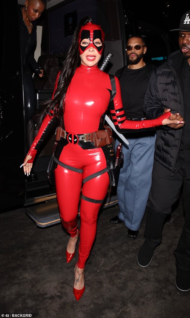 Lala Anthony showed off her curves as Deadpool in a red latex bodysuit on Wednesday as she attended a Halloween party at LAVO