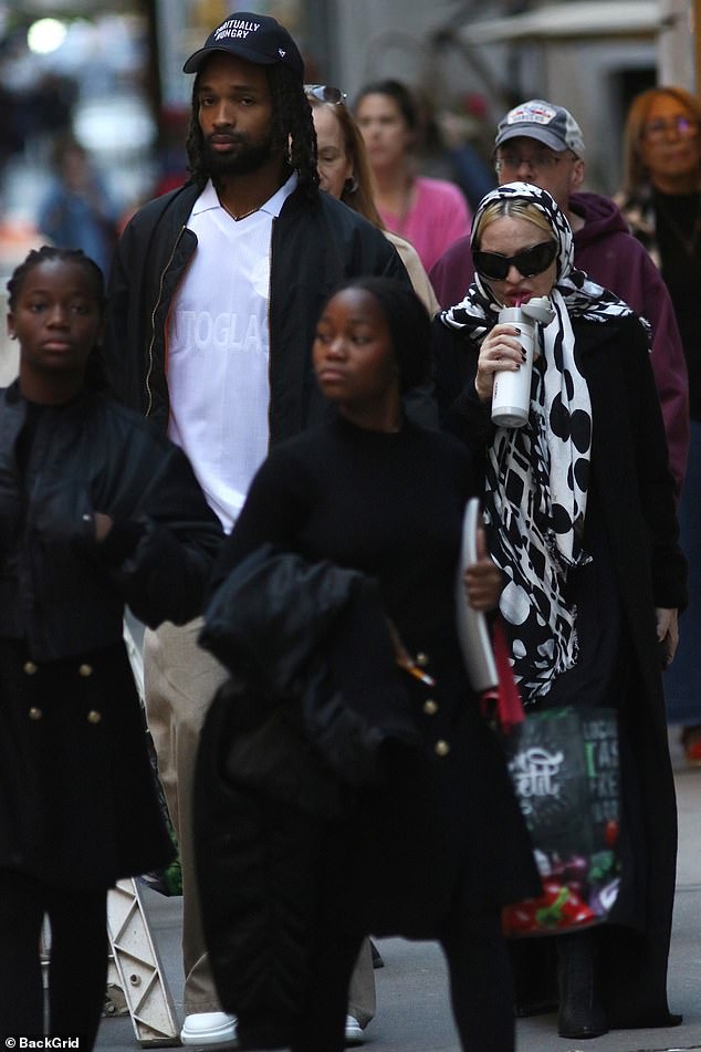 The lovebirds were accompanied by her adopted twin daughters, who wore matching black dresses