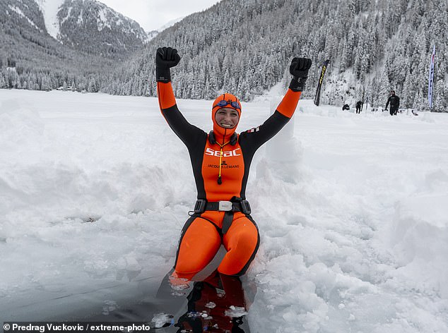 Valentina Cafolla celebrates her world record dive of 140 meters at Lake Anterselva in February