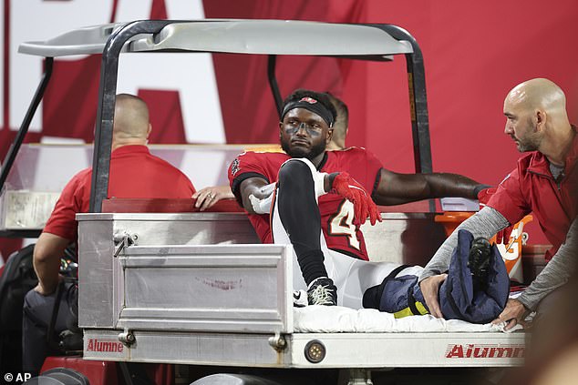 Bucs' star wide receiver Chris Godwin is taken off the field on an air throw with his left ankle