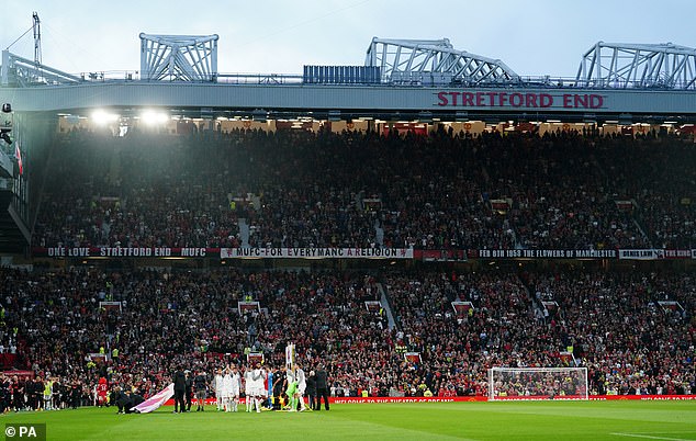 A Manchester United fan was arrested on Saturday after a police officer knocked off his hat at the Stretford End