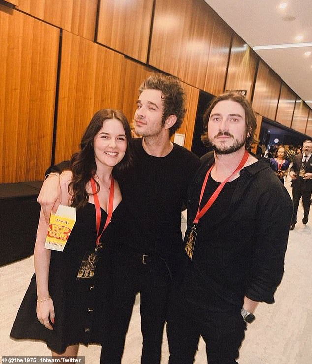 Matt Healy, 35, (centre) arrived Down Under incognito as he was spotted skipping the red carpet at the Gladiator II event and chatting to fans