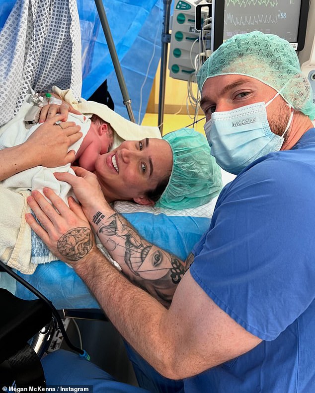 She shared a photo of herself cradling her newborn in the hospital with Oliver by her side, after her C-section and another baby breastfeeding him for the first time