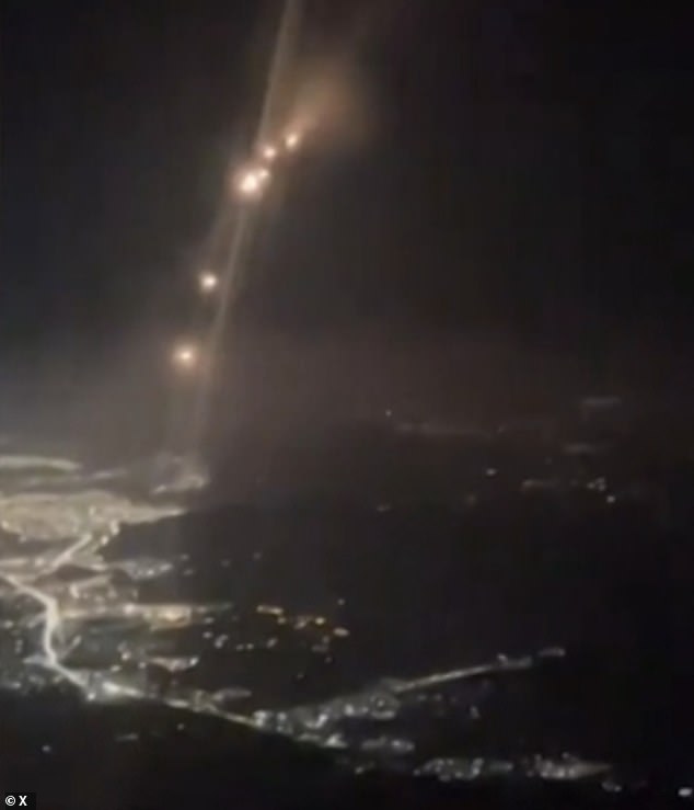 Terrifying footage taken from the cockpit of a plane flying over the Middle East showed the moment a barrage of Iranian missiles soared through the night sky, close to a passenger plane