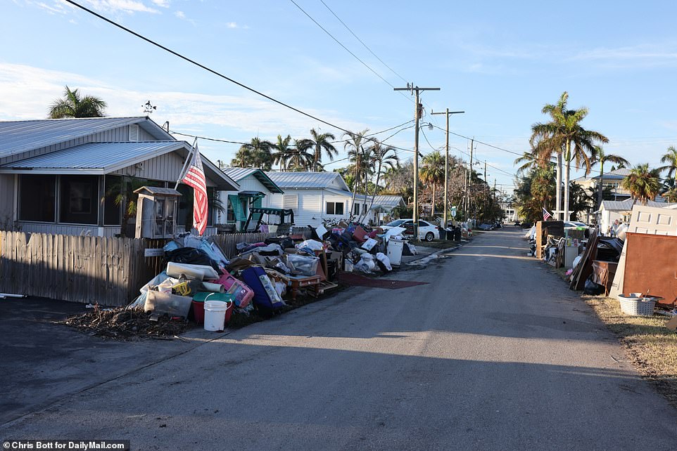 Damaged items and furniture litter the roads of Cortez