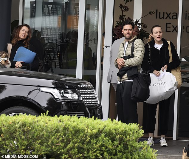 Madeline Holtznagel (far right) was spotted arriving home to Sydney on Tuesday after a family trip to Queenstown with her billionaire boyfriend Justin Hemmes, his ex-partner Kate Fowler and her boyfriend David Oettlé.