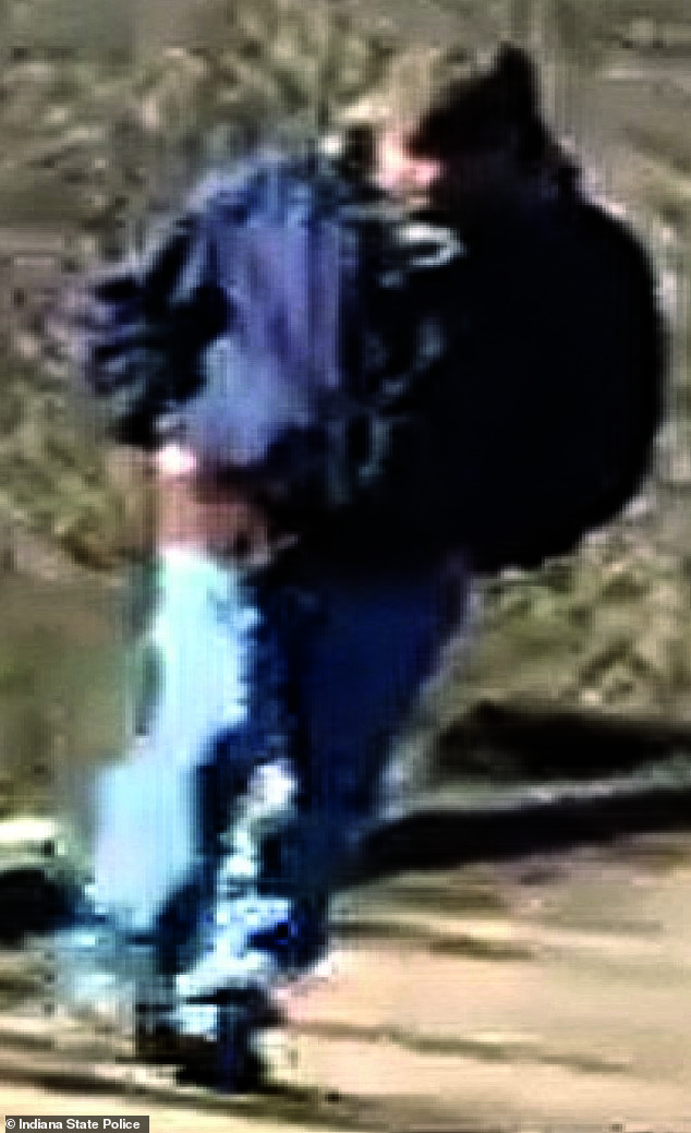 The video showed a man wearing a blue jacket, jeans and a hat walking behind the girls