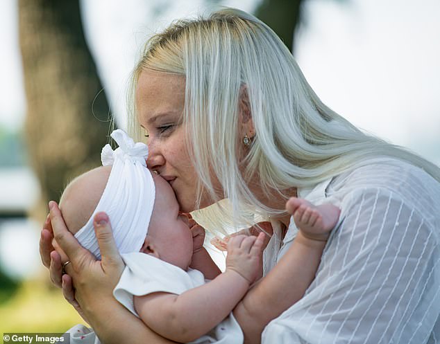 A mother has revealed that her husband does not want her to kiss their son on the forehead or cheek after he reaches the age of two because it will make him 'weak' (stock image)