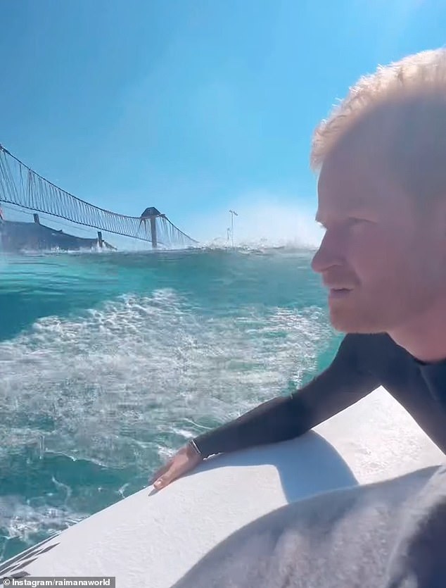 Prince Harry seen here riding next to Raimana Van Bastolaer's jet ski, just before he tamed 'the wave'