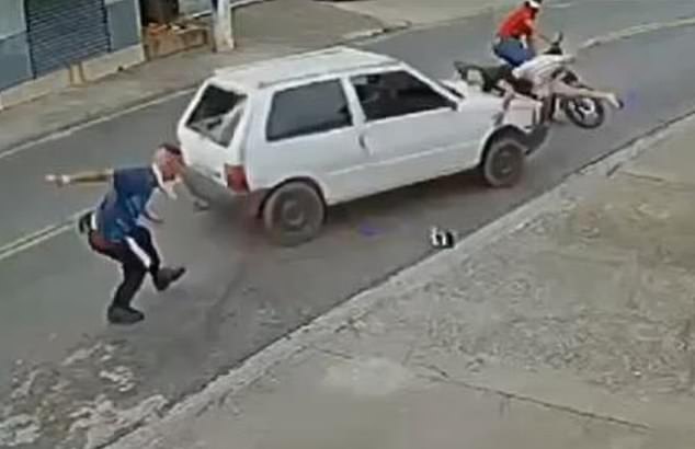 Gustavo Francisco (left) stands up after being run over by Cristian dos Santos, who also rammed into his friend (right)